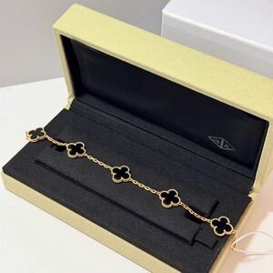Van Cleef & Arpels Elegant Black and Gold Clover Bracelet
